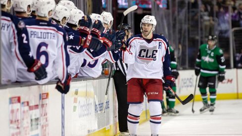 Trent Vogelhuber celebrates scoring a goal by fist bumping his teammates.