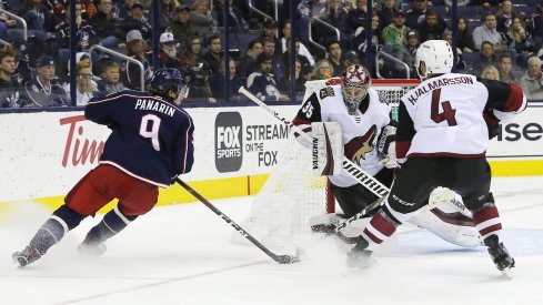 Artemi Panarin takes a shot on Coyotes goaltender Darcy Kuemper