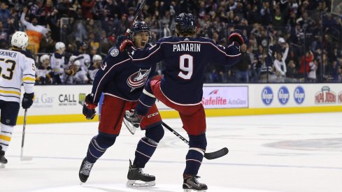 Artemi Panarin celebrates with Seth Jones after his overtime-winning goal against the Sabres on Saturday night.