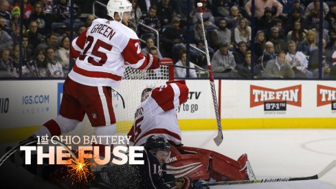 Columbus Blue Jackets center Pierre-Luc Dubois finds himself on the ice around the Detroit Red Wings net...somehow.