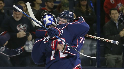 Sergei Bobrovsky and Nick Foligno embrace after a win; the Columbus Blue Jackets have 17 points in 15 games but are still at the top of their division.
