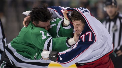 Jamie Benn and Josh Anderson fight early during the Blue Jackets and Stars game.