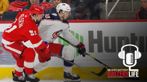 Alex Wennberg skates past Frans Nielsen in a matchup between the Detroit Red Wings and Columbus Blue Jackets