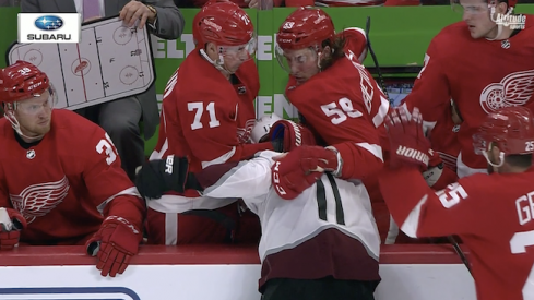 Tyler Bertuzzi of the Detroit Red Wings winds up to sucker punch Matt Calvert of the Colorado Avalanche.