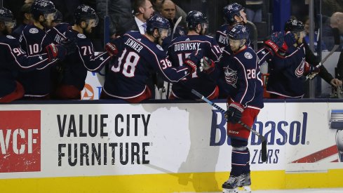 Oliver Bjorkstrand celebrates a goal with the Blue Jackets bench