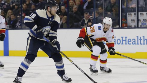 Pierre-Luc Dubois looks to move the puck in The Blue Jackets 9-6 loss to the Calgary Flames