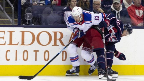 Blue Jackets Markus Nutivaara hits New York Rangers Kevin Hayes into the boards as he tries to get by with the puck