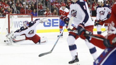 Joonas Korpisalo makes a save on Washington Capitals defenseman John Carlson in the first period at Capital One Arena