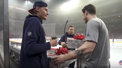 Joonas Korpisalo, Pierre-Luc Dubois, and Cam Atkinson exchange gifts on the latest episode of Blue Jackets' "Behind the Battle" series.
