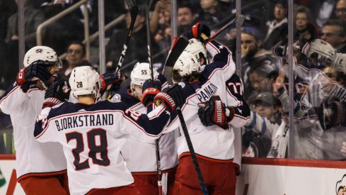 Oliver Bjorkstrand Artemi Panarin Seth Jones and Mark Letestu celebrate with Josh Anderson after his first period goal in Winnipeg.