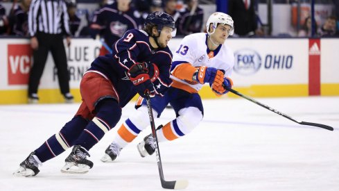 Artemi Panarin skates against Matt Barzal