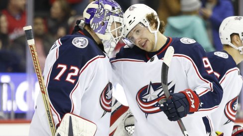 Artemi Panarin and Sergei Bobrovsky celebrate a win. 