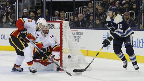 Alexander Wennberg tries to put the puck on net with Mark Giordano trying to track him down