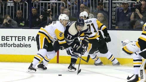 Pittsburgh Penguins defenseman Chad Ruhwedel (2) checks Columbus Blue Jackets right wing Josh Anderson (77) during the second period at Nationwide Arena.