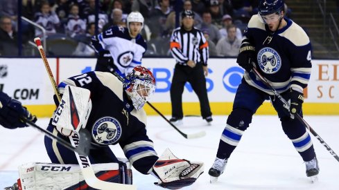 Sergei Bobrovsky attempts to make the save as Scott Harrington reacts against the Winnipeg Jets in the first period at Nationwide Arena.