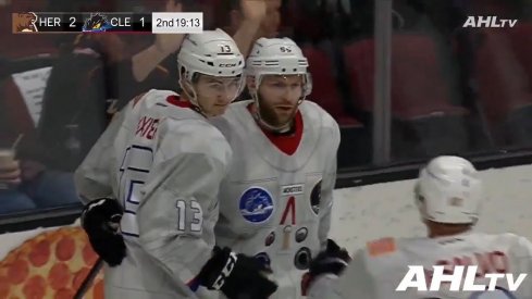 Alexandre Texier celebrates with Mark Letestu after scoring for the Cleveland Monsters