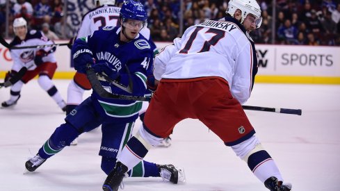 Brandon Dubinsky pursues the puck against the Canucks' Elias Petterson