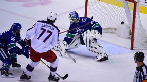 Mar 24, 2019; Vancouver, British Columbia, CAN; Columbus Blue Jackets forward Josh Anderson (77) scores a goal against Vancouver Canucks goaltender Thatcher Demko (35) and defenseman Alex Biega (55) during the third period at Rogers Arena.