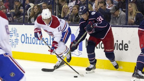 Mar 28, 2019; Columbus, OH, USA; Montreal Canadiens center Max Domi (13) and Columbus Blue Jackets center Riley Nash (20) battle for the puck during the third period at Nationwide Arena.