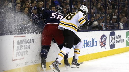 Boston Bruins right wing David Pastrnak (88) checks Columbus Blue Jackets defenseman David Savard (58) during the first period at Nationwide Arena.