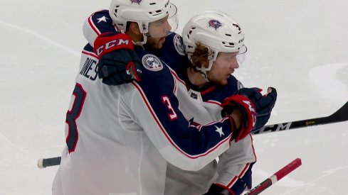 Seth Jones and Artemi Panarin celebrate a goal during Game 2 against the Bruins