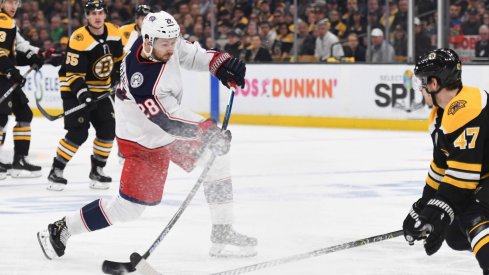 Apr 27, 2019; Boston, MA, USA; Columbus Blue Jackets right wing Oliver Bjorkstrand (28) shoots the puck while Boston Bruins defenseman Torey Krug (47) defends during the first period in game two of the second round of the 2019 Stanley Cup Playoffs at TD Garden.