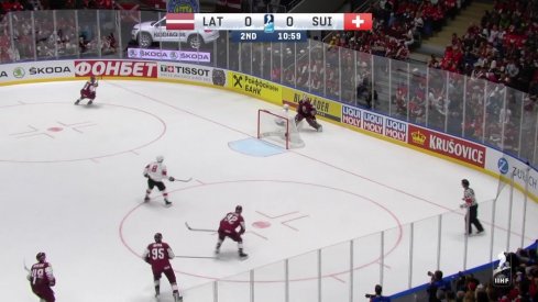 Elvis Merzlikins drops Kevin Fiala to the ice at the IIHF World Championship