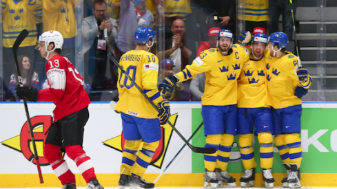 Alexander Wennberg celebrates with the rest of his Sweden teammates as they score a goal against Switzerland