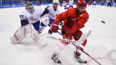 Olympic Athlete from Russia forward Sergei Andronov (11) plays the puck ahead of Norway goaltender Henrik Haukeland (33) and defenseman Mattias Norstebo (10) in the second period of the men's hockey quarterfinals during the Pyeongchang 2018 Olympic Winter Games at Gangneung Hockey Centre. 