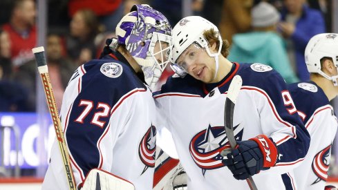Columbus Blue Jackets goaltender Sergei Bobrovsky (72) celebrates with Blue Jackets left wing Artemi Panarin (9) after their game against the Washington Capitals at Capital One Arena.