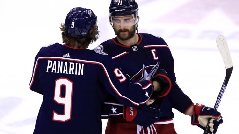 Columbus Blue Jackets left wing Artemi Panarin (9) hugs left wing Nick Foligno (71) after being defeated by the Boston Bruins in game six of the second round of the 2019 Stanley Cup Playoffs at Nationwide Arena. 