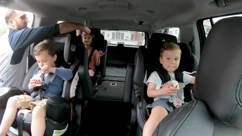 Nick Foligno begins to seat belt his children in anticipation of a car ride.