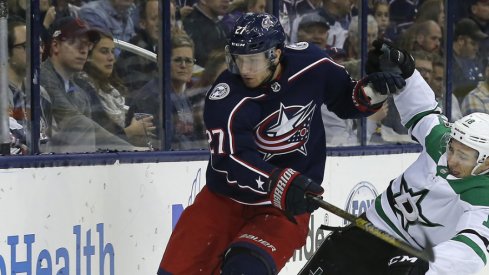 Columbus Blue Jackets defenseman Ryan Murray battles along the boards against the Dallas Stars during a game in November of 2018