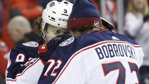 Columbus Blue Jackets left wing Artemi Panarin (9) celebrates with Blue Jackets goaltender Sergei Bobrovsky (72) after scoring the game-winning goal in overtime against the Washington Capitals at Capital One Arena. The Blue Jackets won 2-1 in overtime. 