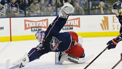 Columbus Blue Jackets goaltender Joonas Korpisalo attempts to stop the puck from entering the net against the Montreal Canadiens during a regular-season matchup at Nationwide Arena in January of 2019.