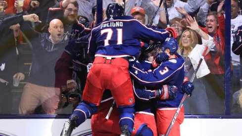 Columbus Blue Jackets forward Nick Foligno jumps onto his teammates to celebrate a goal scored against the Tampa Bay Lightning during the 2019 Stanley Cup Playoffs at Nationwide Arena.