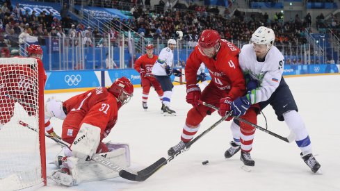 Feb 16, 2018; Gangneung, South Korea; Olympic Athlete of Russia defenseman Vladislav Gavrikov (4) and Slovenia forward Miha Verlic (91) battle for the puck in front of Olympic Athlete of Russia goalkeeper Ilya Sorokin (31) during the third period at the Pyeongchang 2018 Olympic Winter Games at Gangneung Hockey Centre.