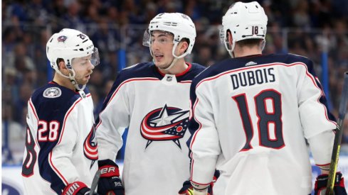 Columbus Blue Jackets forward Oliver Bjorkstrand, defenseman Zach Werenski and center Pierre-Luc Dubois discuss with one another at Amalie Arena during their matchup with the Tampa Bay Lightning in the 2019 Stanley Cup Playoffs.