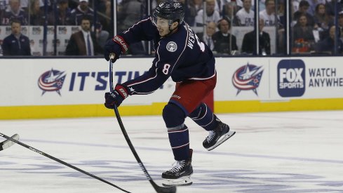 Zach Werenski snaps a puck against the Boston Bruins