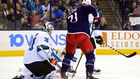 San Jose Sharks goaltender Martin Jones (31) makes a save in his glove as Columbus Blue Jackets left wing Nick Foligno (71) screens in the second period at Nationwide Arena.