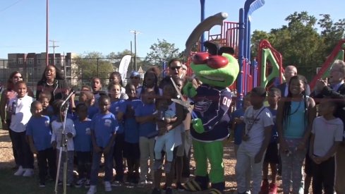 Stinger cuts the ribbon for a new playground that was built.