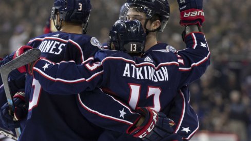 Columbus Blue Jackets forward Cam Atkinson celebrates an empty net goal with Seth Jones in a regular season contest against the Pittsburgh Penguins at Nationwide Arena during March of 2019. 