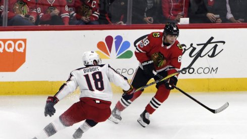 Chicago Blackhawks right wing Patrick Kane (88) is defended by Columbus Blue Jackets center Pierre-Luc Dubois (18) during the first period at United Center. 