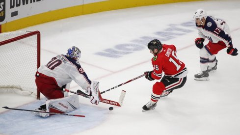 Oct 18, 2019; Chicago, IL, USA; Chicago Blackhawks center Zack Smith (15) tries to score against Columbus Blue Jackets goaltender Elvis Merzlikins (90) during third period at United Center. Mandatory Credit: Kamil Krzaczynski-USA TODAY Sports