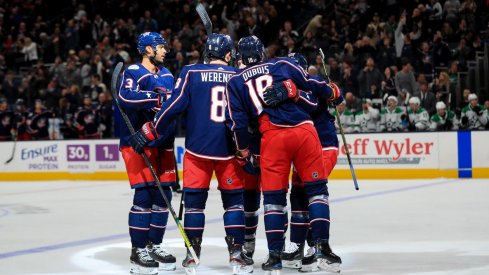 Columbus Blue Jackets defenseman Zach Werenski (8) celebrates with teammates after scoring a goal against the Dallas Stars in the first period at Nationwide Arena. Mandatory Credit: Aaron Doster-USA TODAY Sports
