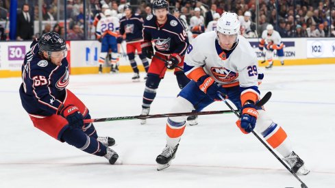 Brock Nelson walks Markus Nutivaara