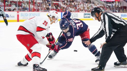 Carolina Hurricanes right wing Sebastian Aho (20) takes a face off against Columbus Blue Jackets center Boone Jenner (38) at PNC Arena. The Columbus Blue Jackets defeated the Carolina Hurricanes 3-2. Mandatory Credit: James Guillory-USA TODAY Sports