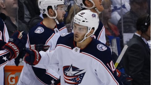 Columbus Blue Jackets center Alexander Wennberg celebrates with his teammates after scoring the game-tying goal in a regular-season matchup against the Toronto Maple Leafs at Scotiabank Arena during October of 2019.