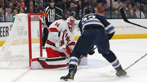 Columbus Blue Jackets left wing Sonny Milano (22) lifts a backhand shot past Carolina Hurricanes goalie Petr Mrazek (34) for a goal during the second period at Nationwide Arena. 