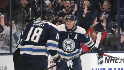 Columbus Blue Jackets forwards Pierre-Luc Dubois and Cam Atkinson celebrate after a game-winning goal in overtime to defeat the Carolina Hurricanes at Nationwide Arena during October of 2019.